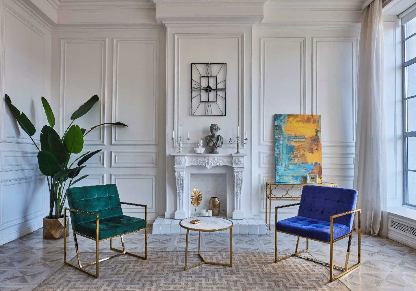 white walls of living room with green and blue single seater sofa with a plant at the corner