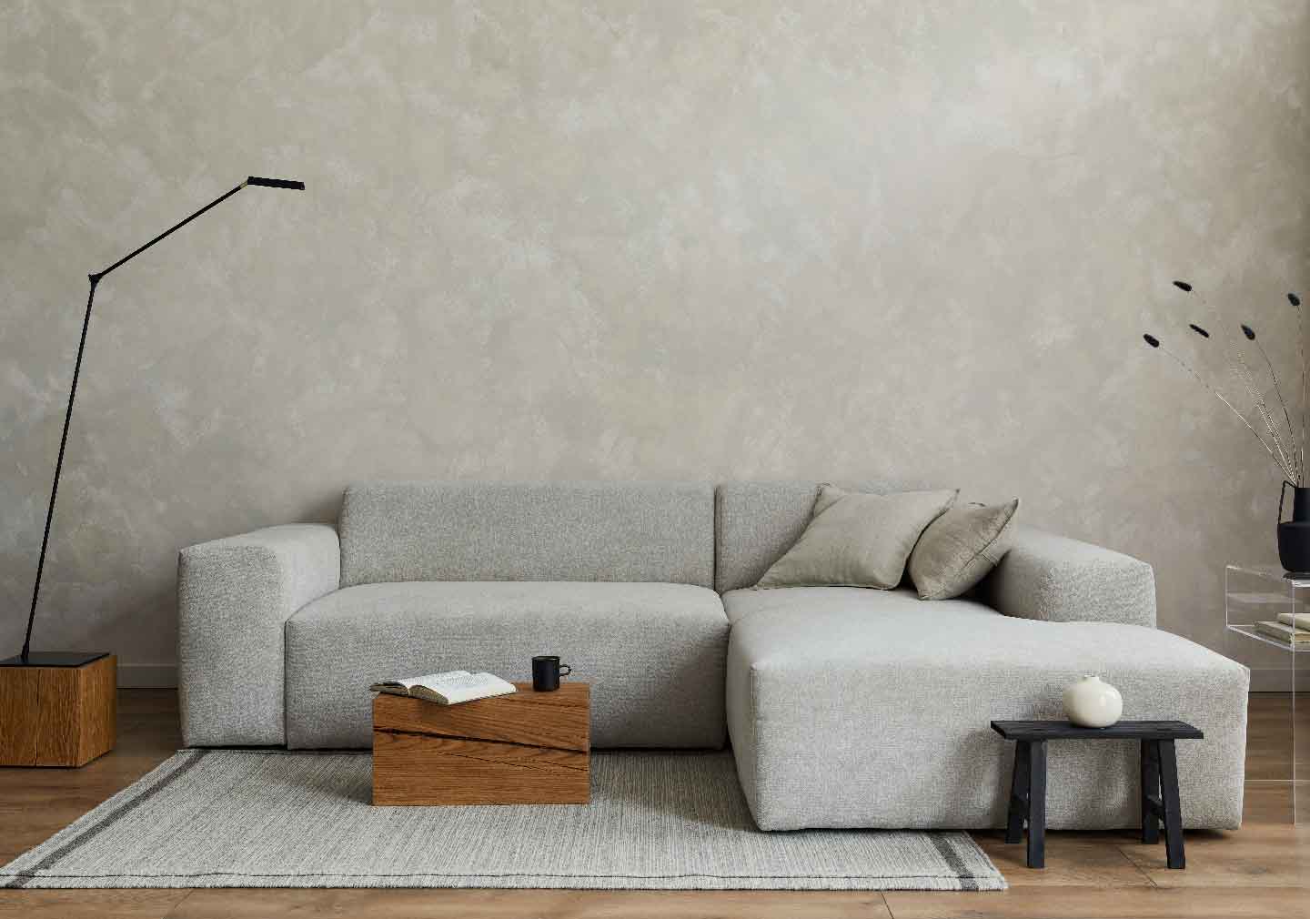 living room interior design with grey sofa with designer wallpaper at the base wall 
