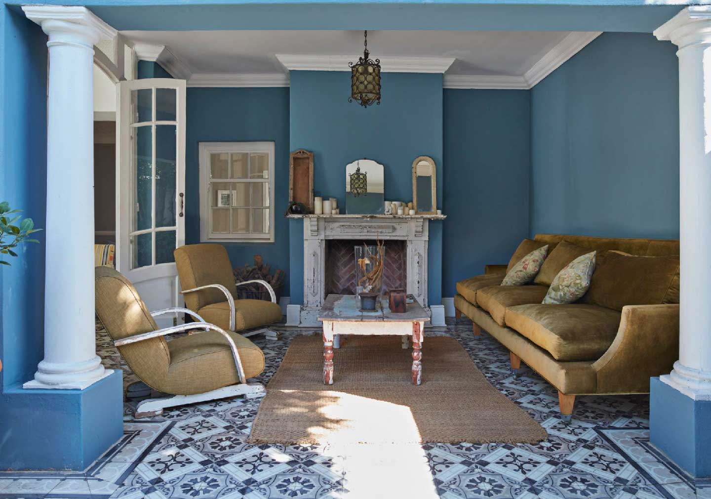 Living Room Design Trends 2023 - blue theme walls with brown sofa and a centre table