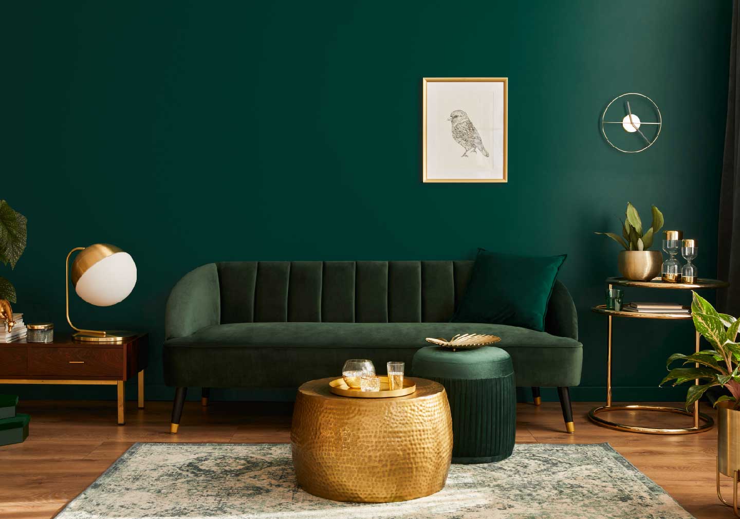 multitasking coffee table with green sofa and green base wall with a photo frame on it.