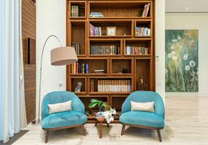 home library design with reading chair and lamp