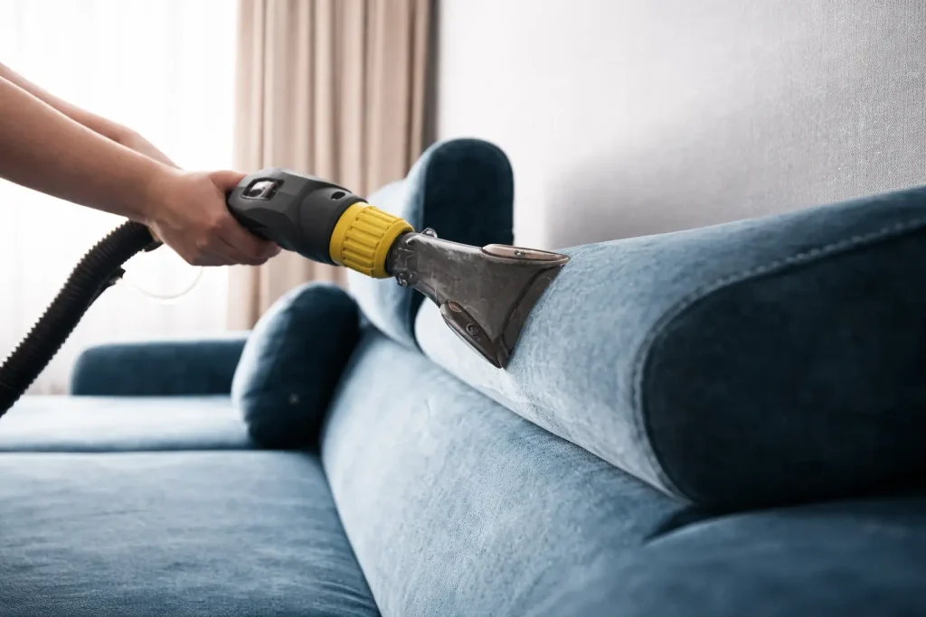 Professional upholstery cleaning machine deep cleaning blue velvet sofa at home