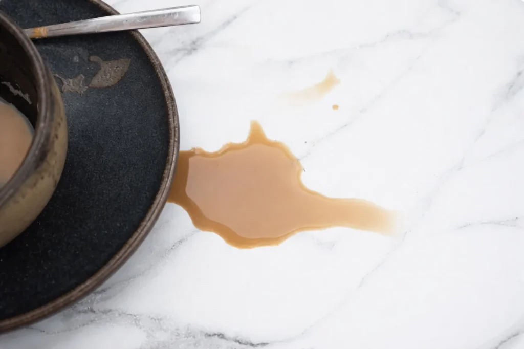 Coffee spill on white marble surface showing marble stain absorption