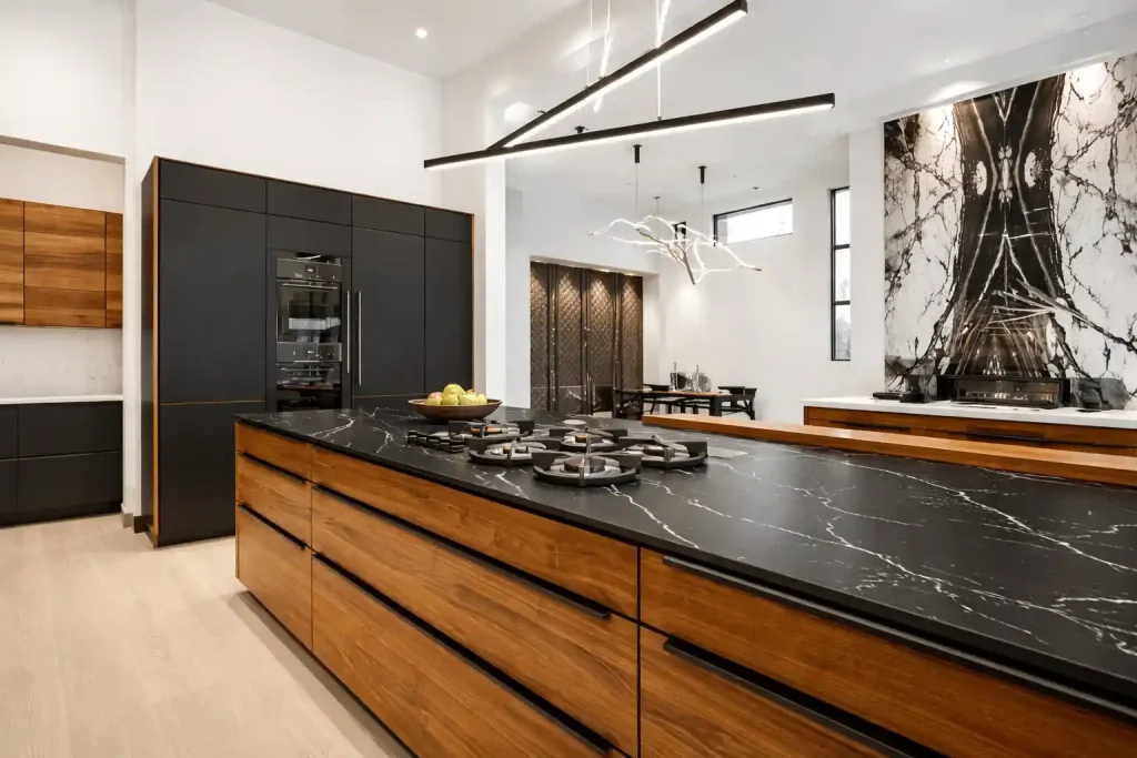 Modern luxury kitchen with walnut cabinets and black marble island countertop