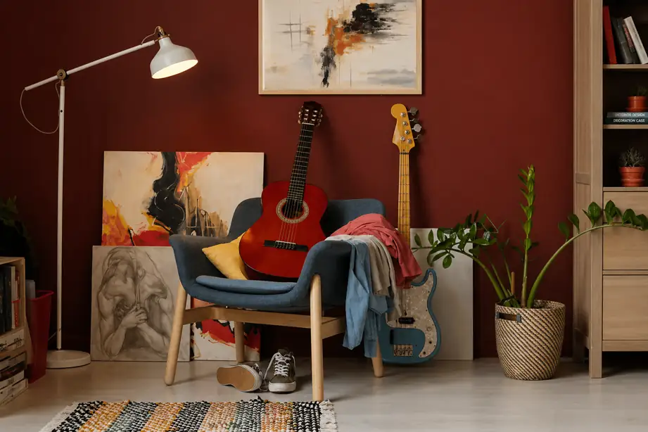 cozy music corner with acoustic guitar, bass guitar, chair and warm interior decor