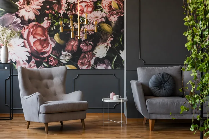 Minimalist Scandinavian living room with gray sofas, wooden furniture, green cushions, and natural decor