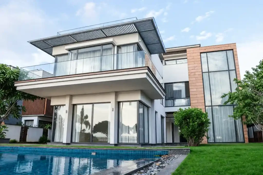 Modern luxury villa with swimming pool, large glass windows, and contemporary architectural design